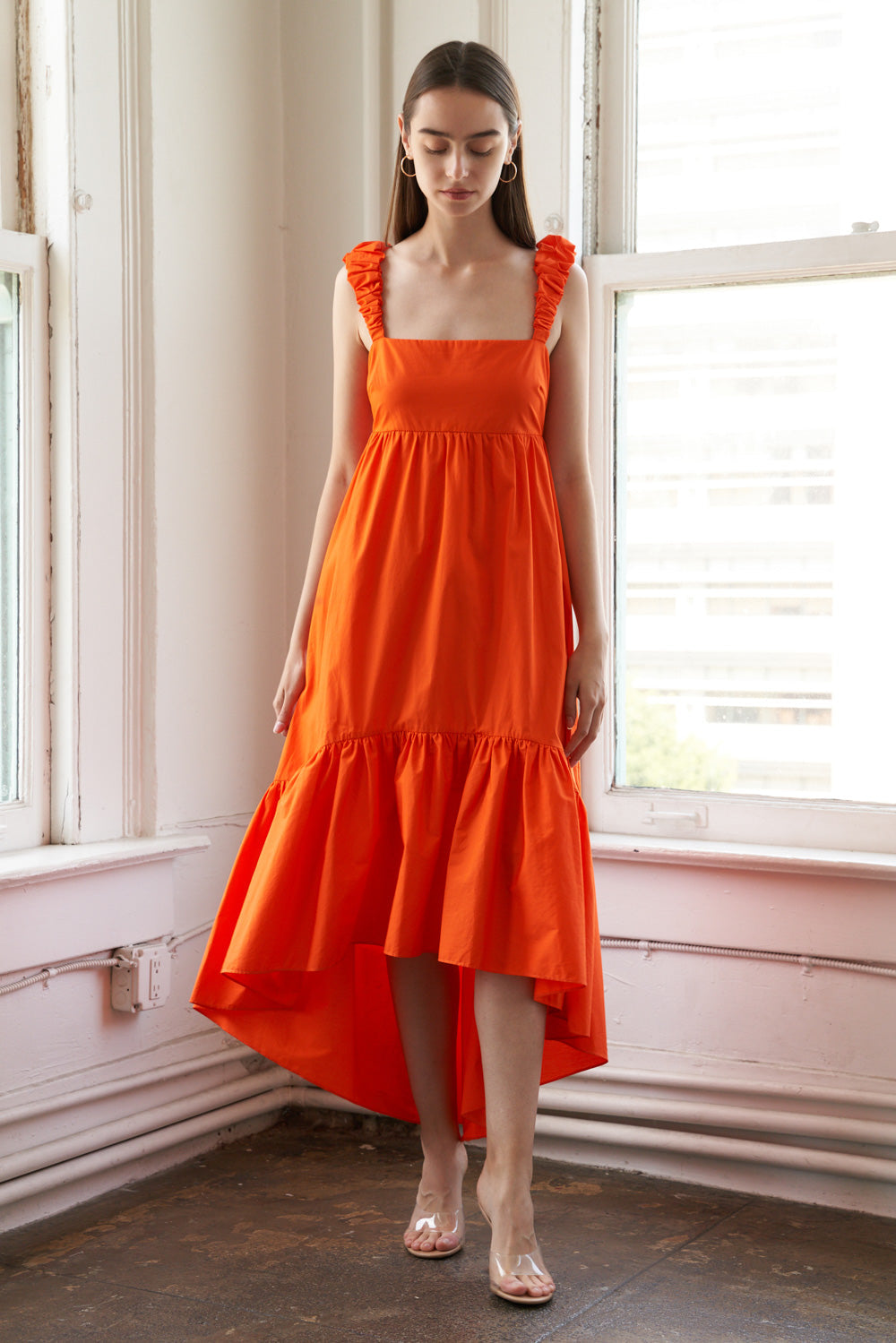 A solid woven midi dress featuring straight neckline, gathered strap, ruffle hemline, hi-lo and back zipper closure Details: Self : 79% Polyester 17% Rayon 4% Spandex Size & Fit - Model is 5`9" And Wearing Size Small - Measurements Taken From Size Small - Approx. Length: 46"