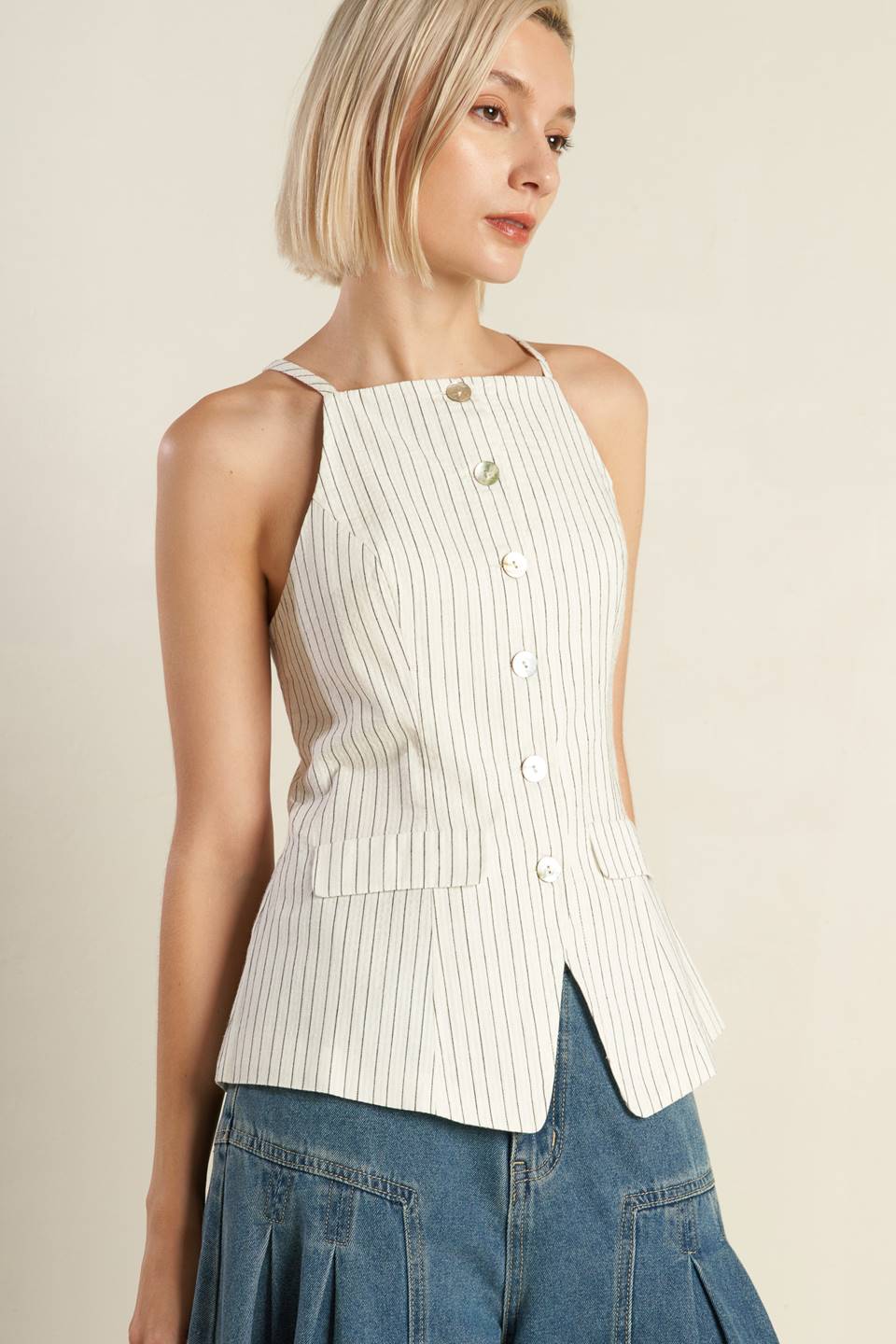 A woven seersucker top featuring sleeveless, button down and faux pocket. Matching pant FP1474