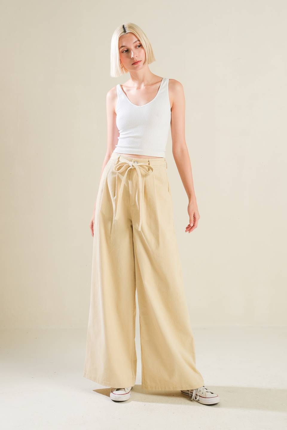 A solid woven pant featuring front closure, self sash tie, front pleat and wide leg  Details:  Self : 75% Cotton 25% Polyester  Size &amp; Fit  - Model is 5`9" And Wearing Size Small - Measurements Taken From Size Small - Approx. Length: 43"