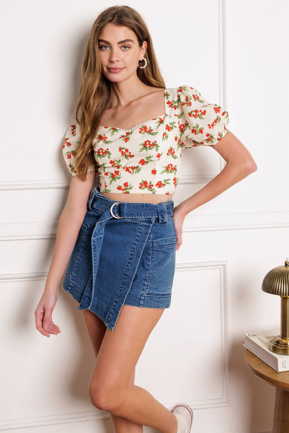 A printed woven crop top featuring sweetheart neckline with lace edge, short puff sleeve and smocked back bodice.